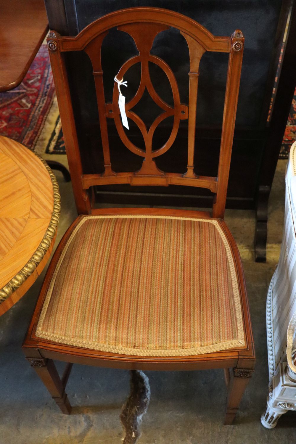 A parcel gilt satinwood centre table, width 113cm height 62cm, and a pair of Edwardian satinwood salon chairs